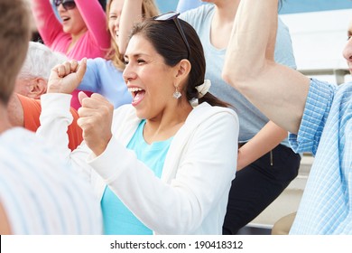 Woman In Crowd Celebrating At Sports Event