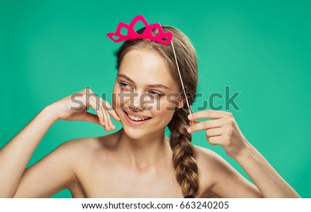  Woman with a crown on a stick on a green background                              