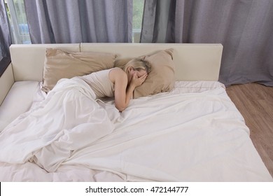 Woman Crying In Bed. Loneliness After A Breakup With A Man, A Divorce With Her Husband. Emotional Coldness