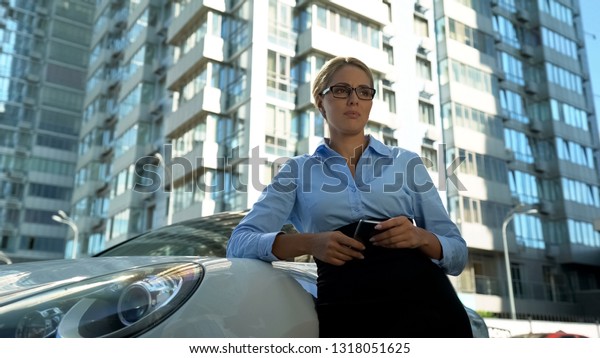 Woman crying near automobile, financial\
difficulties, inability to pay car\
loan
