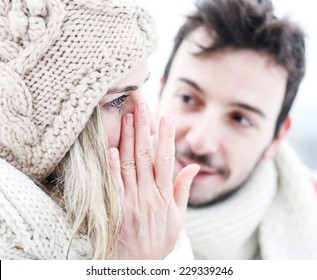 Woman Crying Near Man In Winter And Wiping Tear Off Her Face