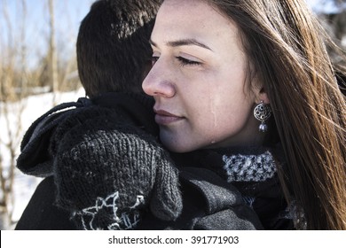 A Woman Crying Near Man In Winter And Wiping Tear Off Her Face