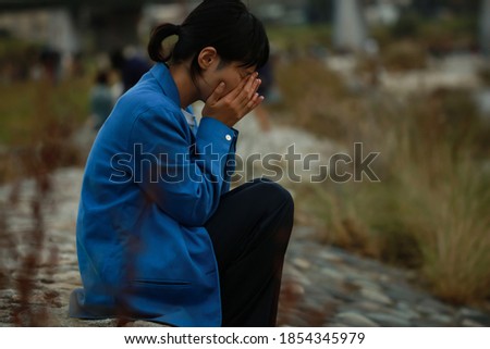 Woman crying on the riverbed