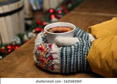 Woman With Cup Of Mulled Wine At Counter, Closeup