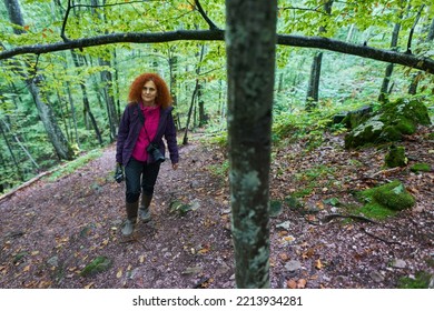 Woman With Curly Hair, Nature Photographer, Hiking In The Mountain Forests