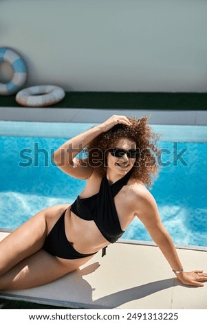 Similar – Brunette surfer woman in bikini standing with surfboard