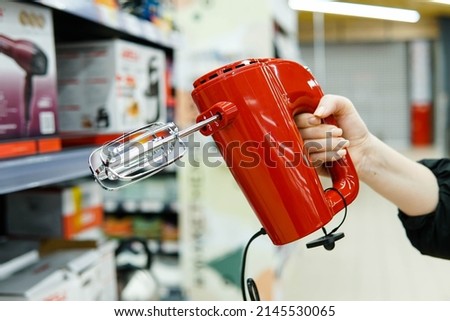 Woman customer choosing new kitchen mixer in household appliances store. Close up.