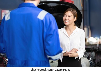 woman customer meeting mechanic and talking about how to fix a car in automobile repair shop - Powered by Shutterstock