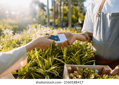 Woman Customer Is Paying By Credit Card In Garden Centre. Money Transaction. 