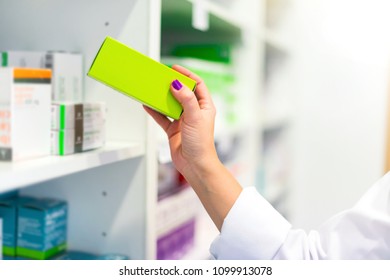 Woman Customer In The Pharmacy Taking A Medicine Box