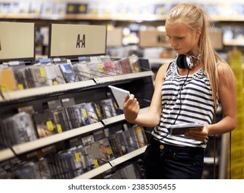 Woman, customer or shopping for music disc, cd or album in store playlist selection, decision and choice. Thinking student, person and musician with headphones reading multimedia information by shelf