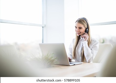 Woman Customer Support Operator With Headset And Smiling