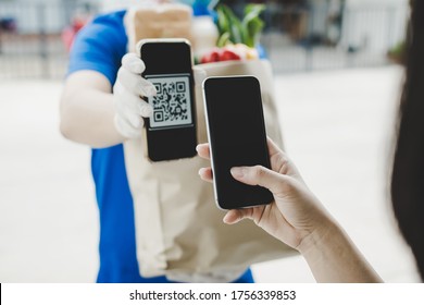 Woman Customer Using Digital Mobile Phone Scan QR Code Paying For Buying Fresh Food Set Bag From Food Delivery Service Man, Express Delivery, Digital Payment Technology And Fast Food Delivery Concept