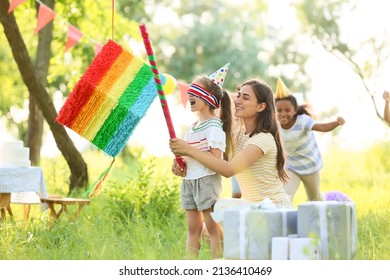 Woman and cute children at pinata birthday party - Powered by Shutterstock