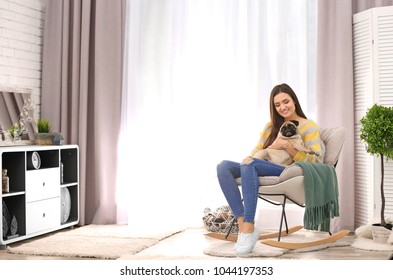 Woman With Cute Dog At Home. Friendship Between Pet And Owner