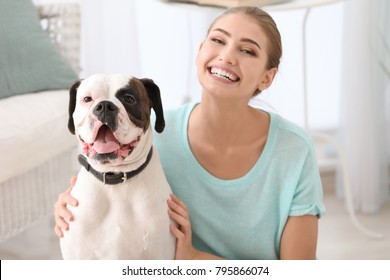 Woman With Cute White Boxer Dog Indoors. Pet Adoption