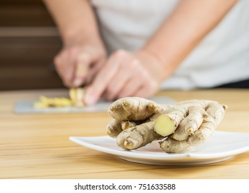 Woman Cuts A Ginger Root