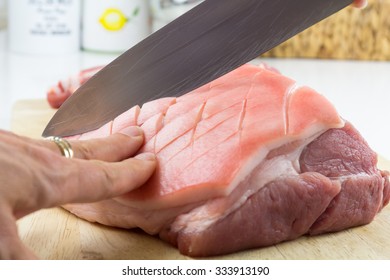 A Woman Cuts Raw Pork - A Pork Roast With Crackling