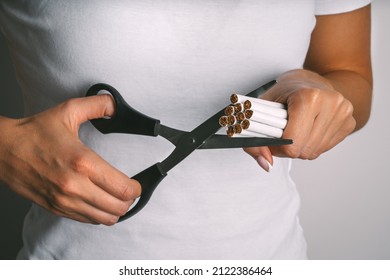 Woman cutting cigarettes with scissors . Stop smoking, quit smoking or no smoking. Woman refusing tobacco and quit bad habit