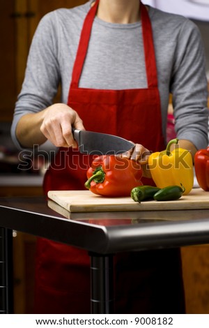 woman cutting fresh bell peppers
