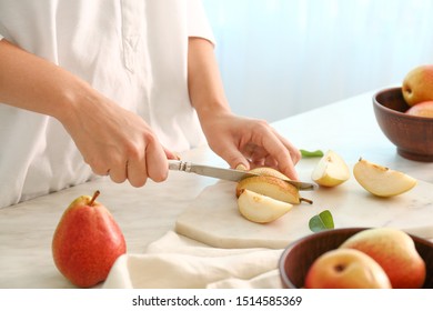 Woman cutting fresh pears at table, closeup - Shutterstock ID 1514585369