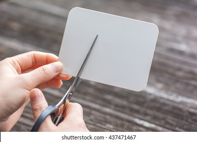 Woman Cutting Paper By Scissors