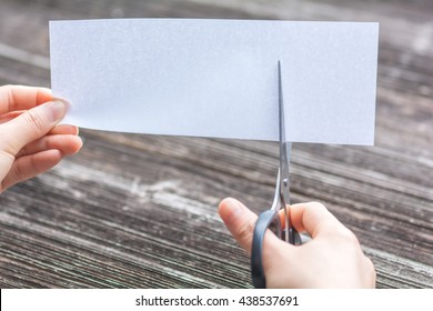 Woman Cutting Paper By Scissors