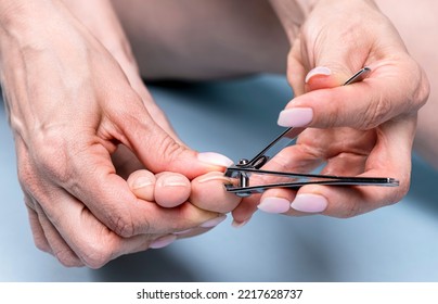 Woman Cutting Toe Nails  With Nail Clippers, Pedicure Concept