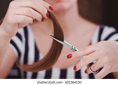 Woman Is Cutting Tress With The Scissors