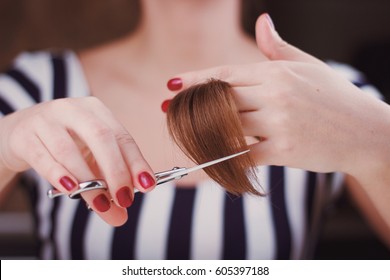 Woman Is Cutting Tress With The Scissors