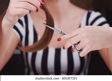 Woman Is Cutting Tress With The Scissors