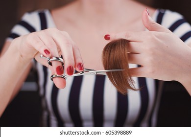 Woman Is Cutting Tress With The Scissors