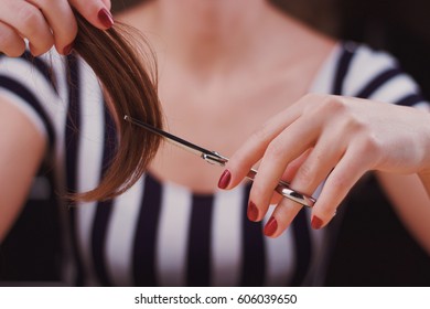 Woman Is Cutting Tress With The Scissors