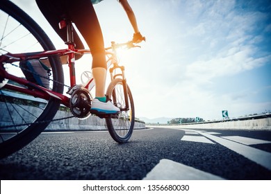 Woman Cyclist Legs Riding Mountain Bike On Highway