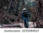 Woman cyclist riding a mountain bike on a nature trail. Take a break. Living a healthy lifestyle