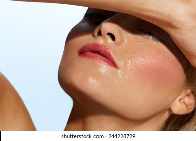 Woman with damp face covering from sun.