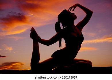 A Woman In A Dance Or Yoga Pose In The Sunset