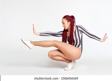 Woman Dancer Of Modern Dance Posing On A White Background. Dance Vog, Dance Hall. Afro Braids Of Bright Color