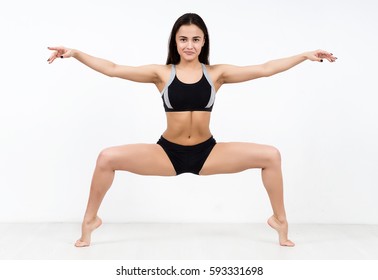 Woman dancer in plie position isolated on white background