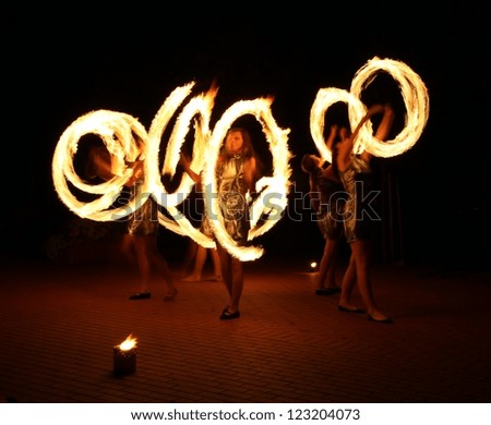 Woman dancers with a fire, night show