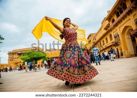 Woman dancing inside the courtyard of Amber Fort, Jaipur, Rajasthan, India, It is UNESCO World Heritage Site.
