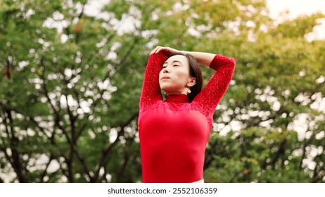 Woman, dancing and stretching arms in park for warm up, fitness or ready for performance in nature. Person, dancer and rehearsal for concert, creative or recital with art, talent and prepare in Japan - Powered by Shutterstock