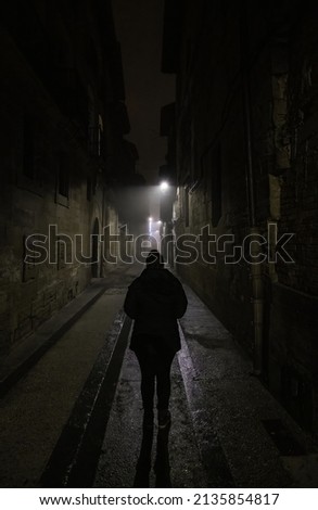 Woman in dark street walking, creepy person,fear