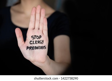 Woman In Darkness Holding Hand Into The Light With Words Stop Clergy Predators Written On It, To Protest The Cover-up Of Sexual Abuse In The Church