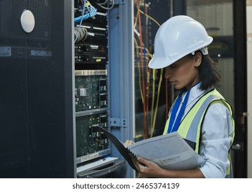 Woman, data center and server room for internet infrastructure and inspection of computer. Network engineer, IT support and cybersecurity with neon, software and company info for cloud computing