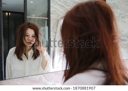 woman with decadent life face herself in the bathroom at morning