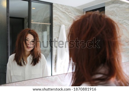 woman with decadent life face herself in the bathroom at morning