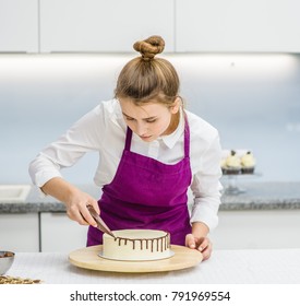 Woman Is Decorating The Cake