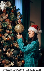 Woman Decorating Christmas Tree With Sparking Ornament. Party Host Preparing For Holidays Decorating The House