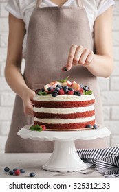 Woman Decorating Delicious Cake